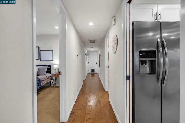 a view of hallway with livingroom and furniture