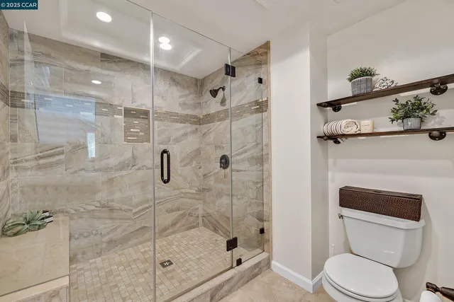 a bathroom with a shower a toilet and sink