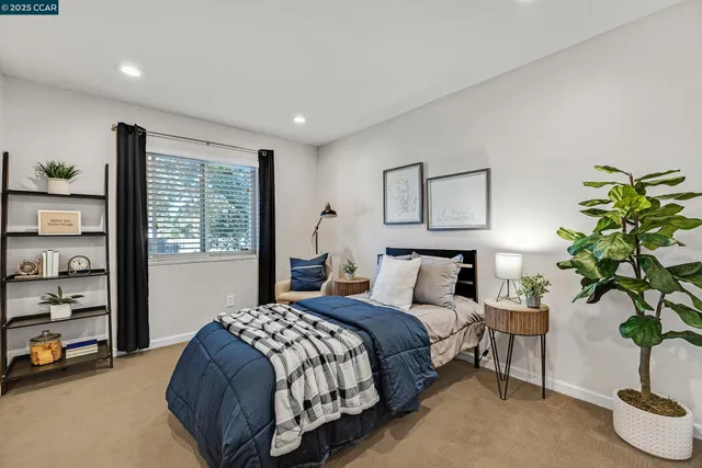 a bedroom with a bed and a potted plant