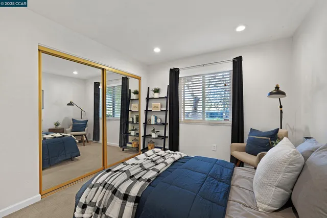 a bedroom with bed and glass door