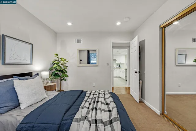 a bedroom with a bed and a painting on the wall