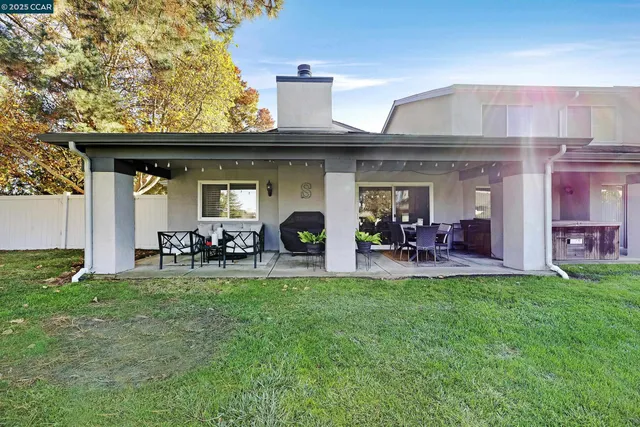 a view of a house with backyard porch and sitting area