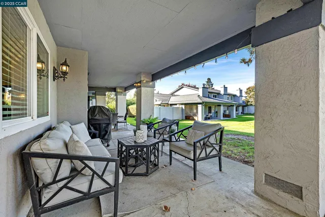 a dining room with furniture and a floor to ceiling window