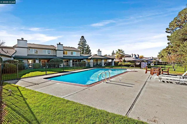 a view of a swimming pool with an outdoor seating and a yard