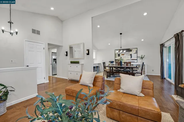a living room with furniture and kitchen view