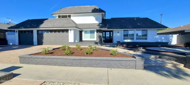 a front view of a house with yard
