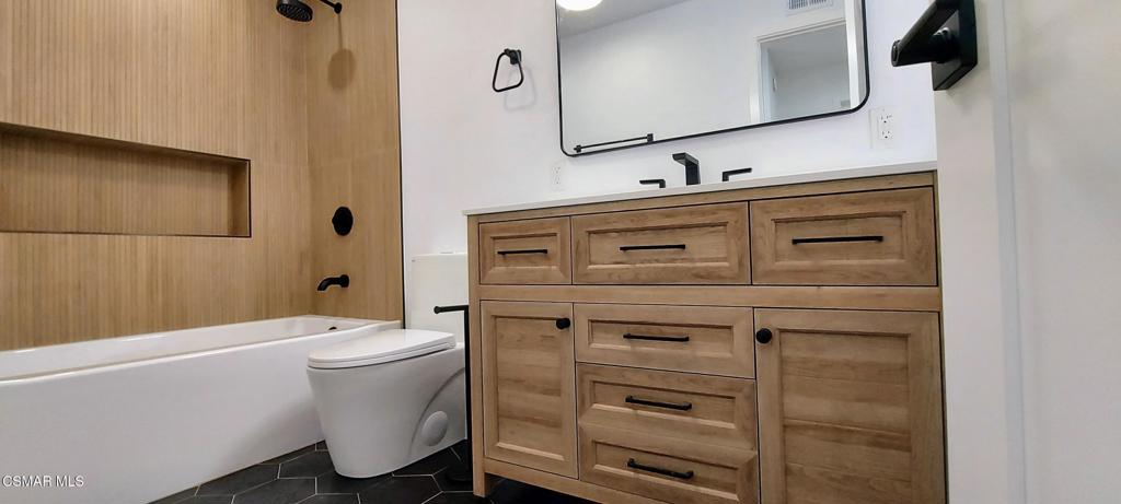 4071 Peoria Avenue Simi Valley, CA 93063 - Photo 15 of 19 a bathroom with a sink toilet and mirror