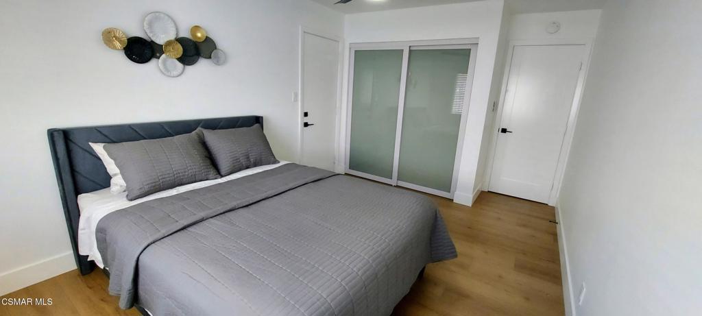 4071 Peoria Avenue Simi Valley, CA 93063 - Photo 17 of 19 a bedroom with a bed and a painting on the wall