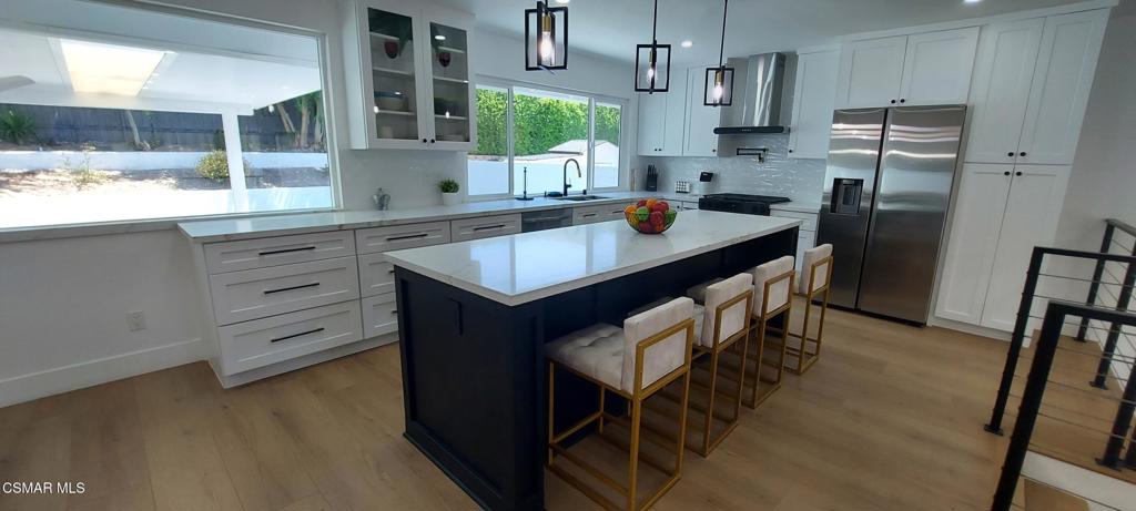 4071 Peoria Avenue Simi Valley, CA 93063 - Photo 3 of 19 a kitchen with stainless steel appliances granite countertop a sink a stove a refrigerator and a window