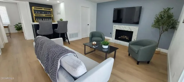 a living room with furniture wooden floor and a fireplace