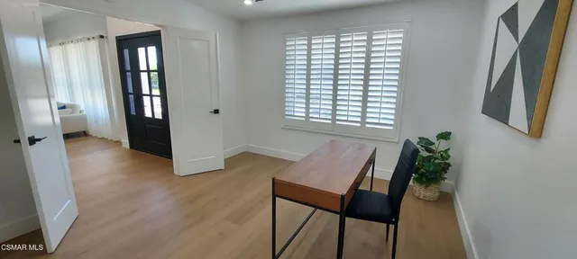 a view of a room with furniture and wooden floor