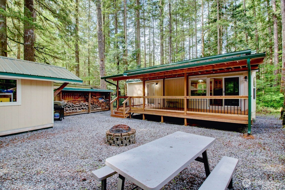 a view of a house with a backyard and sitting area