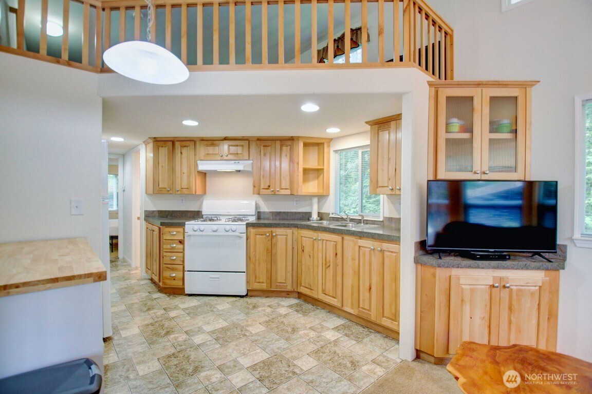 20 Goldrush Road Deming, WA 98244 - Photo 3 of 40 a kitchen with stainless steel appliances kitchen island granite countertop a stove and a sink