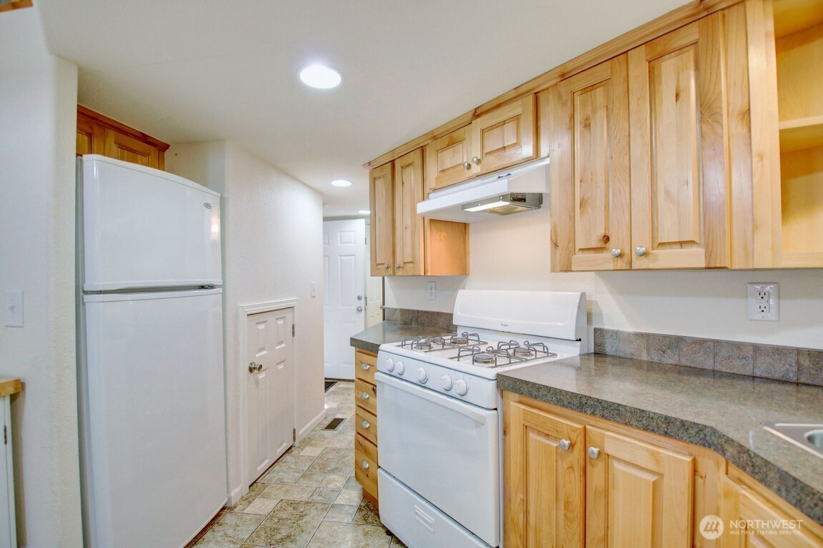 20 Goldrush Road Deming, WA 98244 - Photo 4 of 40 a kitchen with stainless steel appliances granite countertop a refrigerator a stove and a sink