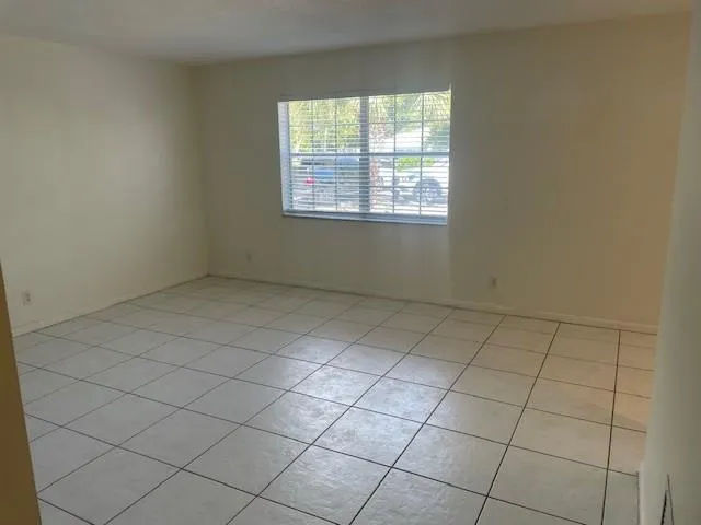 a view of an empty room and a window