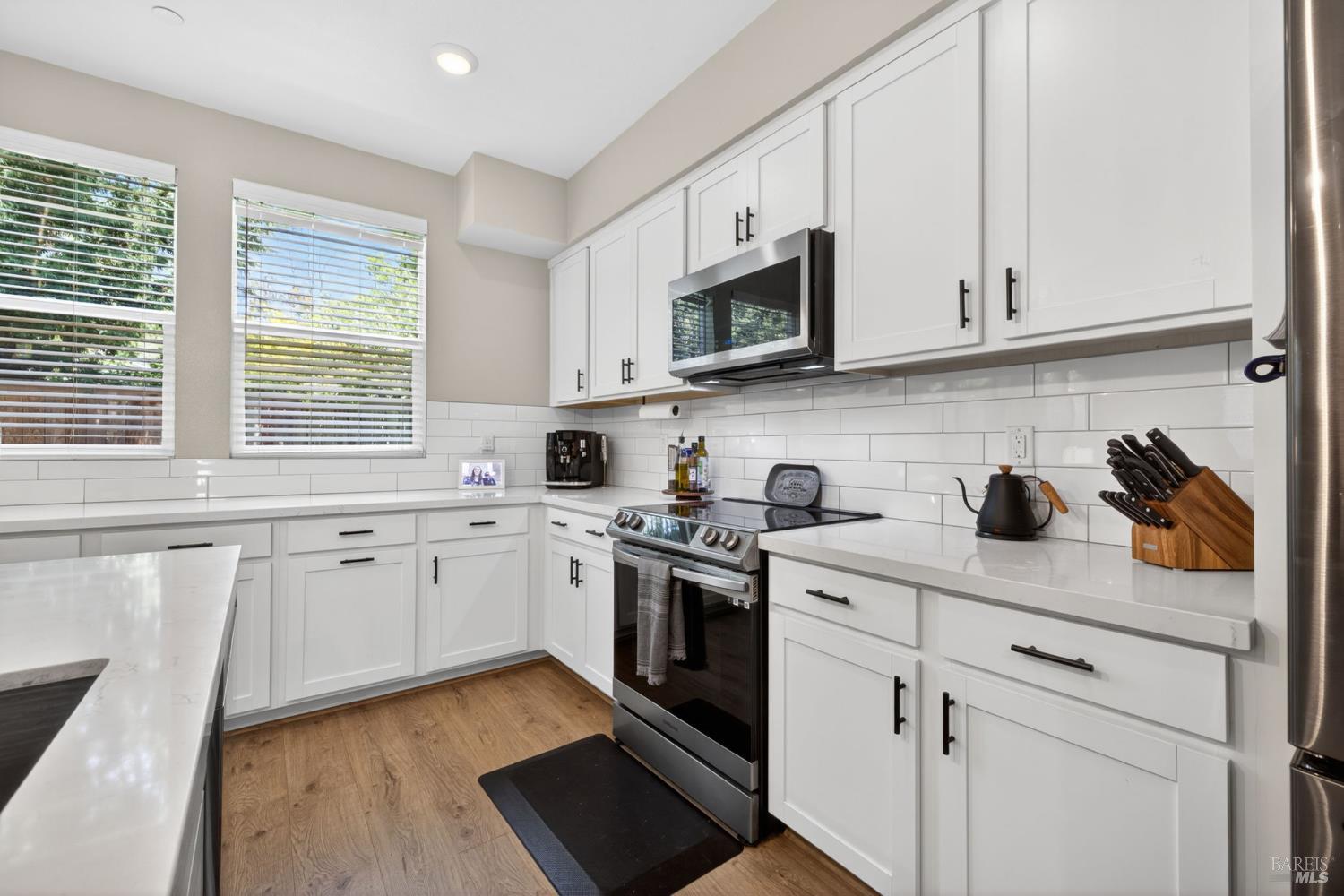 2215-2217 Versaro Drive Santa Rosa, CA 95403 - Photo 9 of 45 a kitchen with stainless steel appliances granite countertop white cabinets a sink and a stove