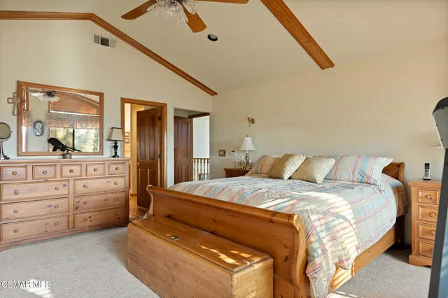 a bedroom with a bed and a dresser