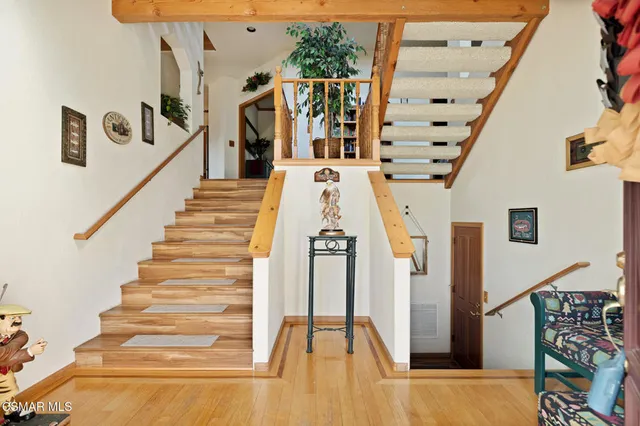 a view of entryway and hall with wooden floor