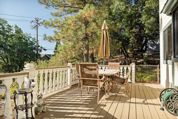 a view of balcony with chairs and wooden floor