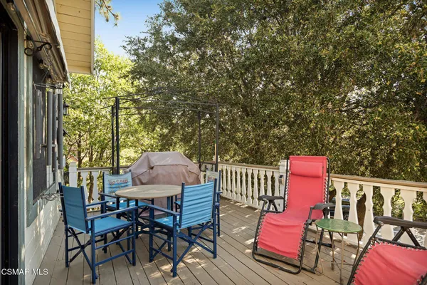 an outdoor sitting area with couch and wooden fence