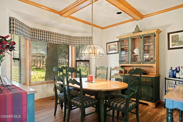 a view of a dining room with furniture and chandelier