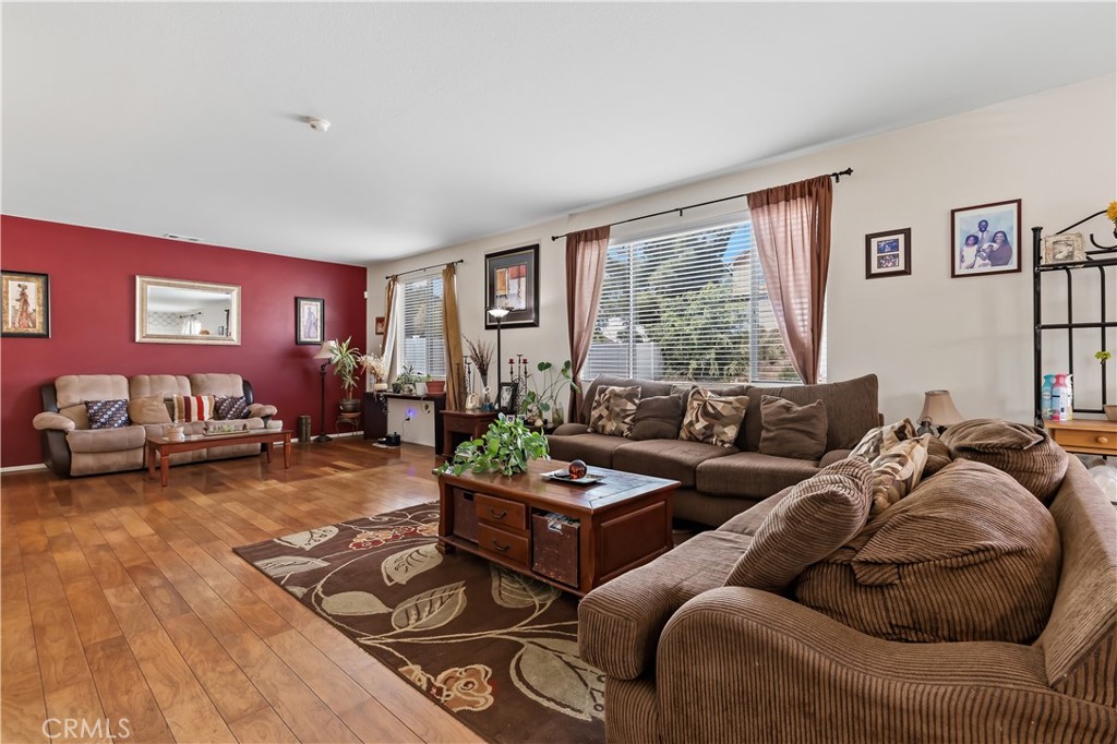 152 Alabaster Loop Perris, CA 92570 - Photo 17 of 29 a living room with furniture and a large window