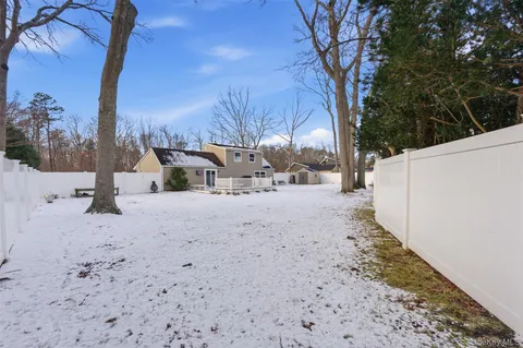 a view of a yard covered in snow