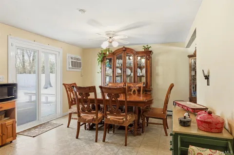 a dining room with furniture and natural light
