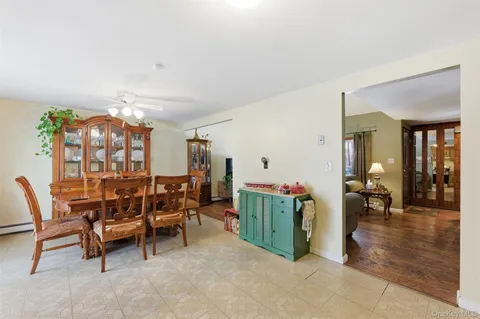 a living room with furniture a large window and kitchen view