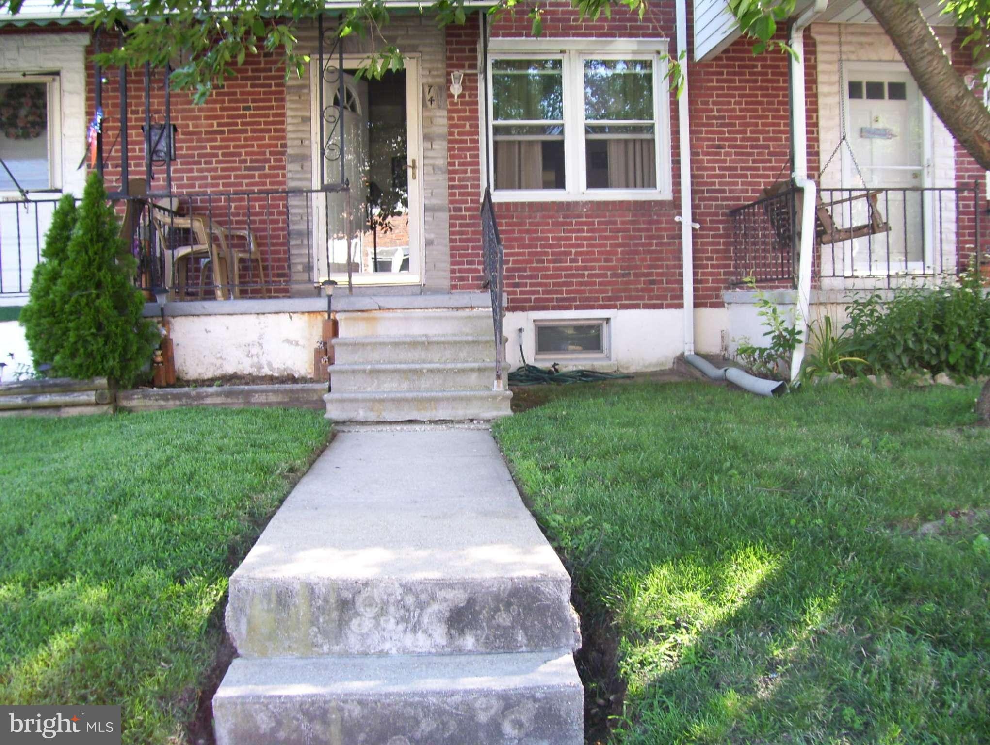 74 Wiltshire Road Baltimore, MD 21221 - Photo 1 of 11 front view of a house with a yard