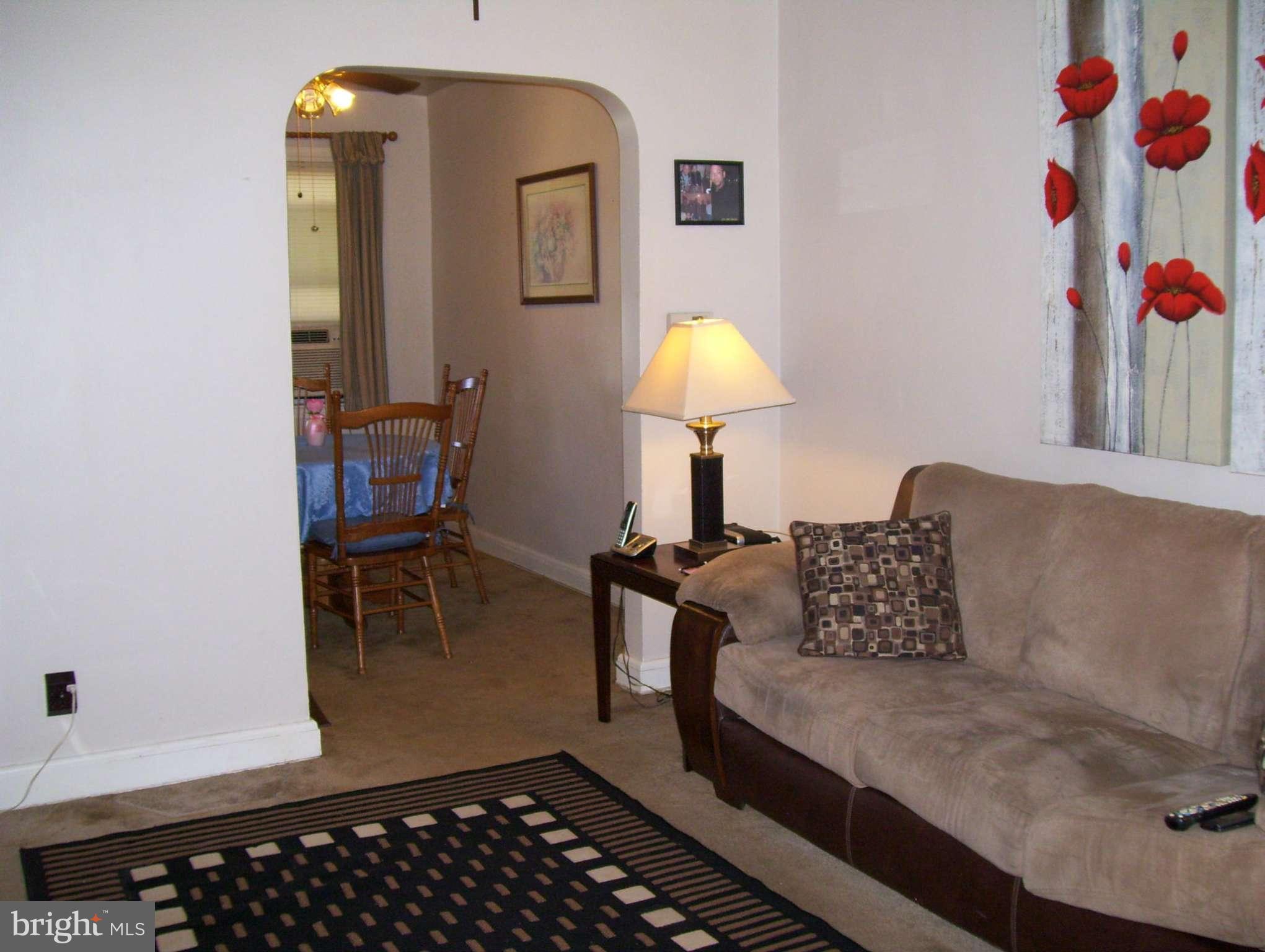74 Wiltshire Road Baltimore, MD 21221 - Photo 3 of 11 a living room with furniture and a lamp