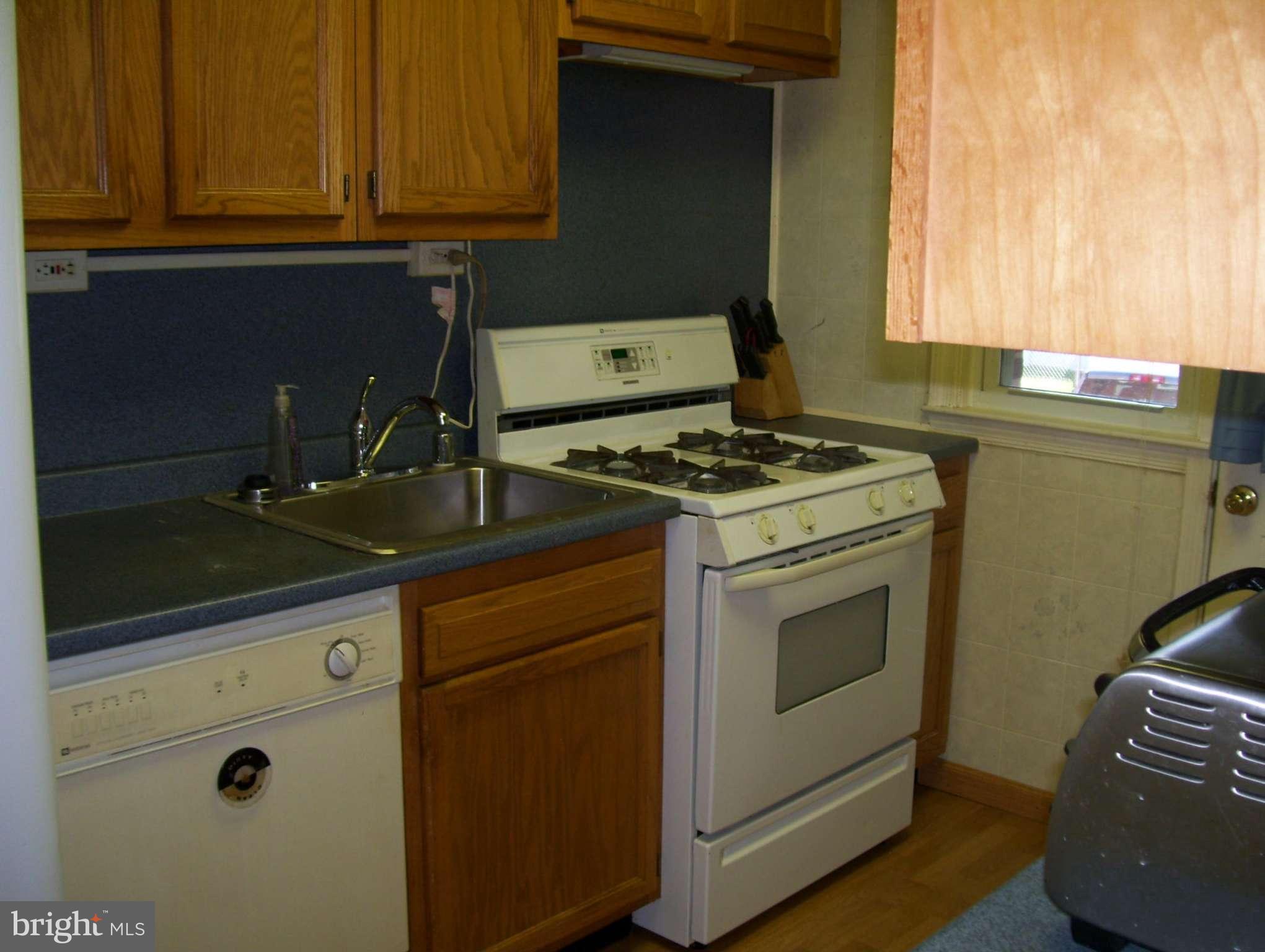 74 Wiltshire Road Baltimore, MD 21221 - Photo 4 of 11 a stove top oven sitting inside of a kitchen