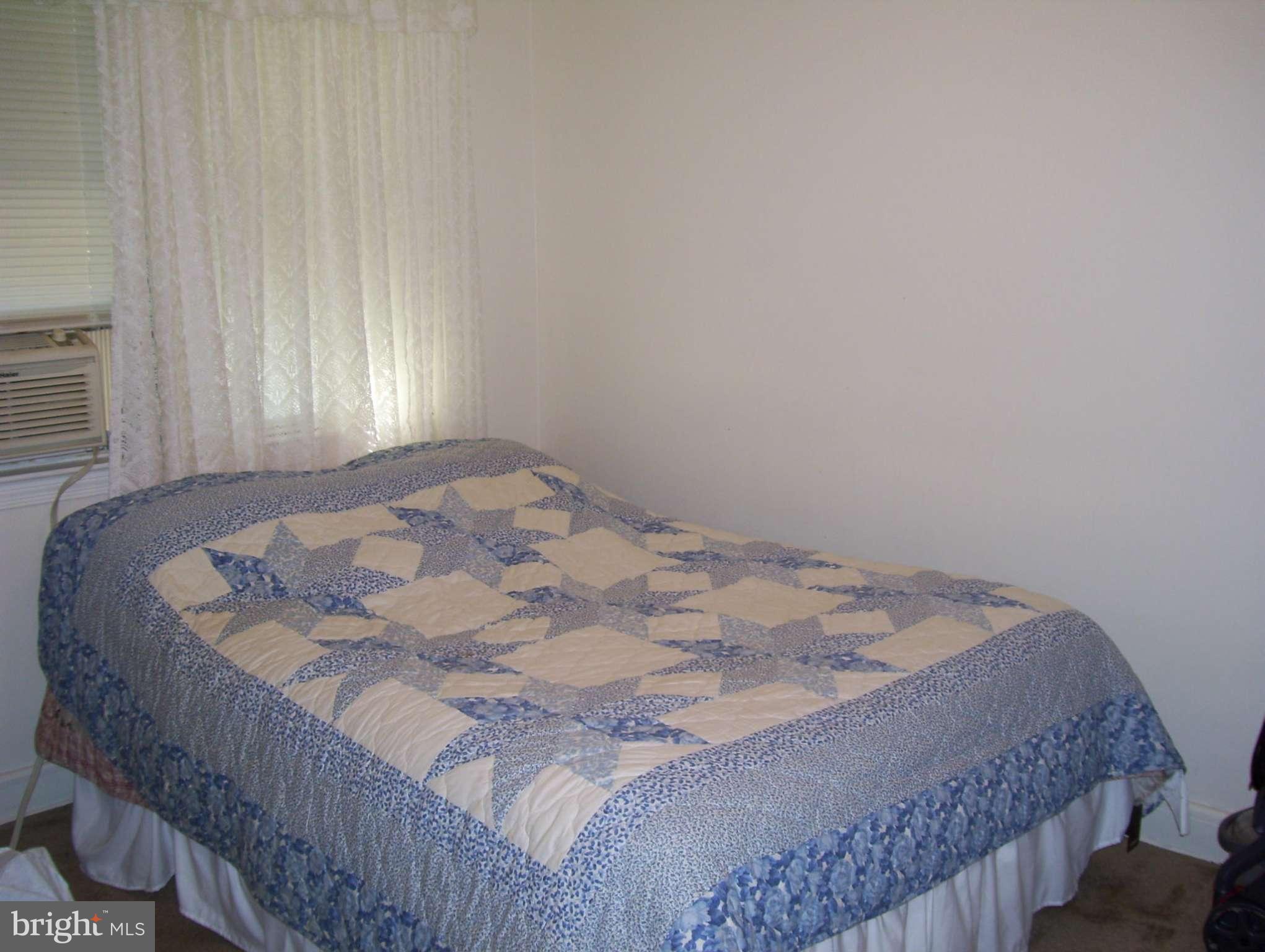 74 Wiltshire Road Baltimore, MD 21221 - Photo 7 of 11 a bedroom with a bed and window