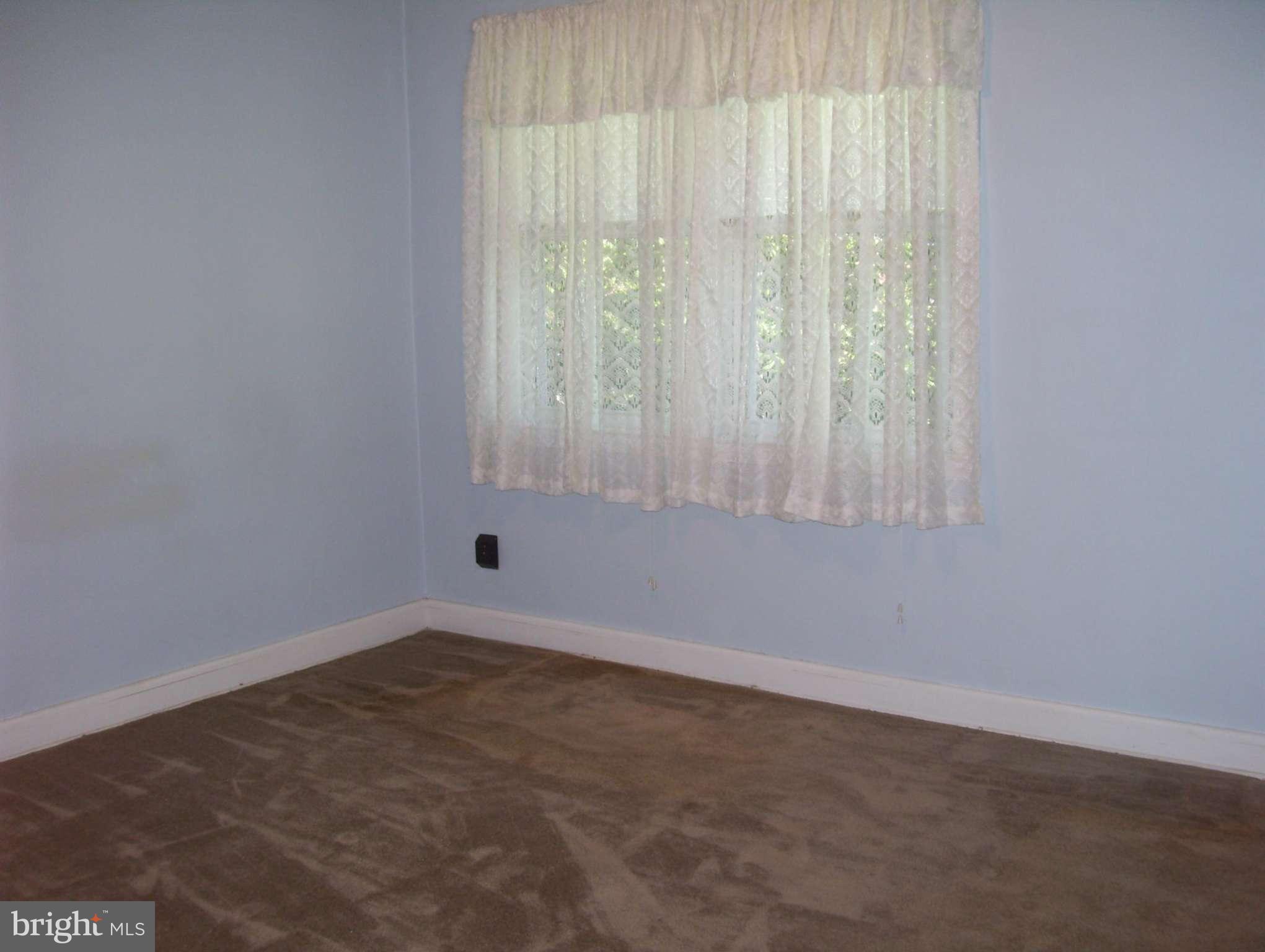 74 Wiltshire Road Baltimore, MD 21221 - Photo 8 of 11 an empty room with a window