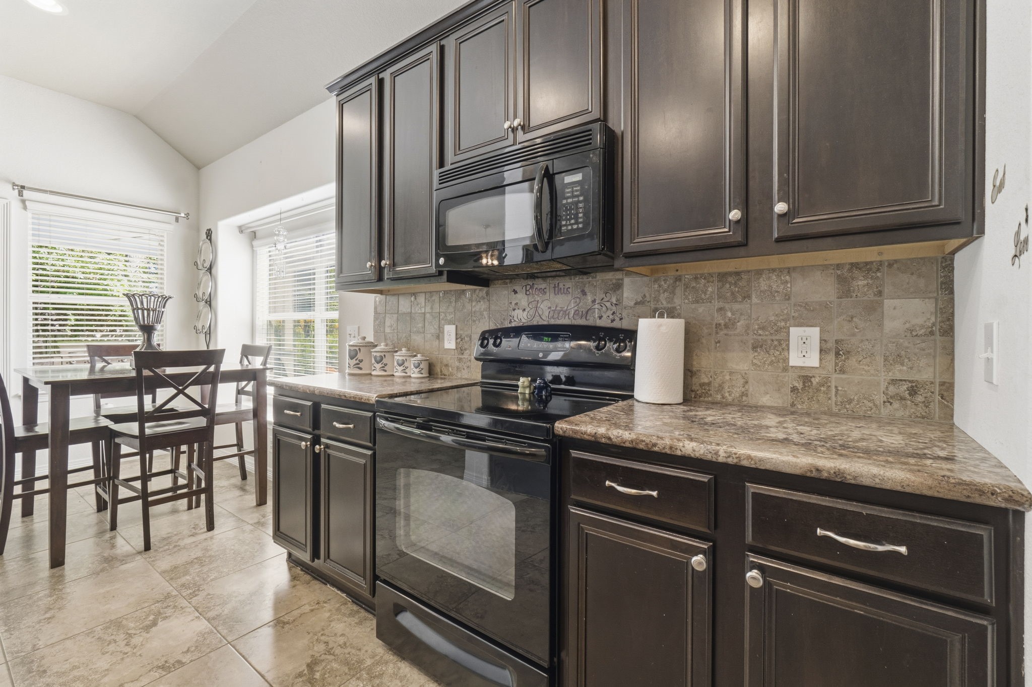 10802 Windswept Montgomery, TX 77356 - Photo 29 of 42 a kitchen with stainless steel appliances granite countertop a stove a sink and a microwave