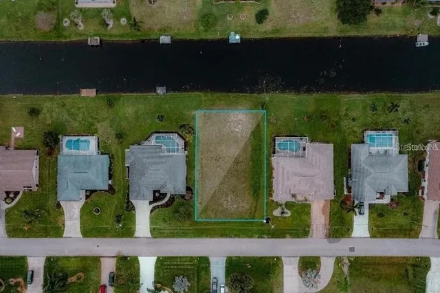 an aerial view of a house with a garden and a yard