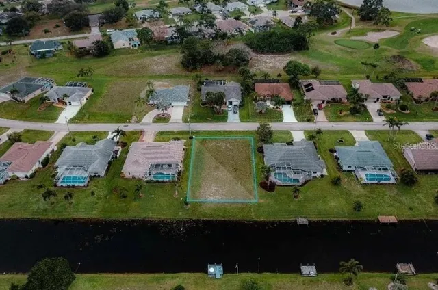 an aerial view of houses with yard swimming pool and outdoor seating