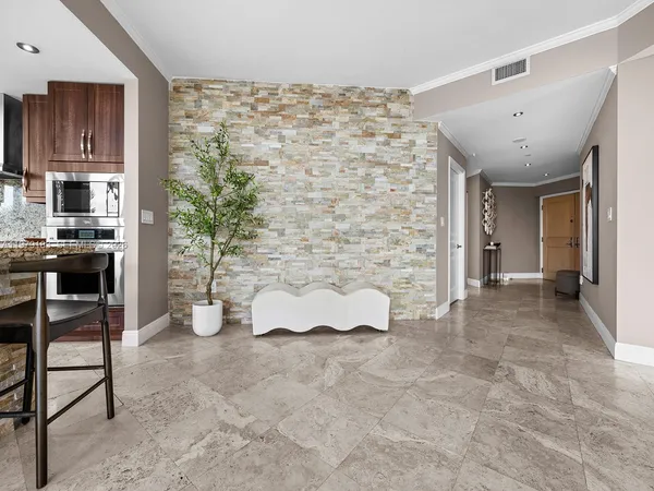 a view of a livingroom with furniture and an empty room