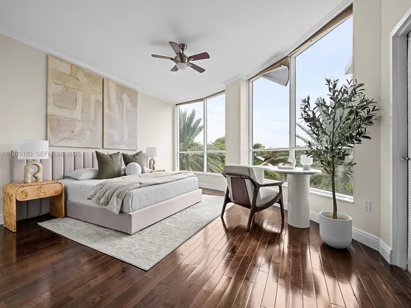 a spacious bedroom with a bed and wooden floor