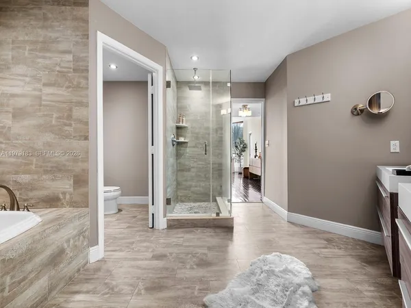 a bathroom with a glass shower door