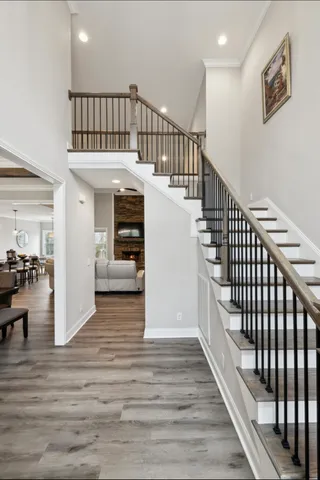 a kitchen with stainless steel appliances granite countertop a stove a sink a island with a dining table and chairs