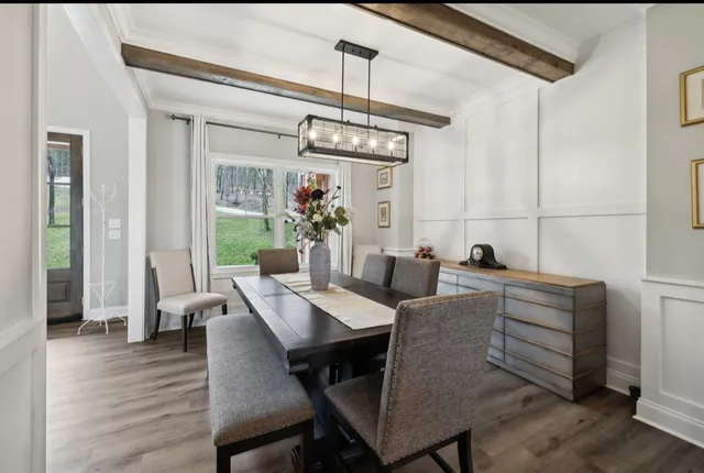 a kitchen with stainless steel appliances granite countertop a stove a sink a microwave a island with a dining table and chairs