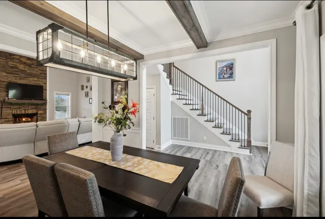 a kitchen that has a lot of cabinets in it and wooden floors