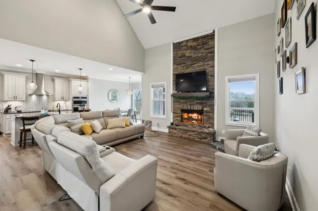 a dining room with furniture a chandelier and wooden floor