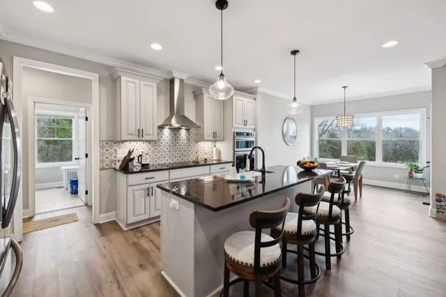 a bathroom with a granite countertop double vanity sink and a mirror
