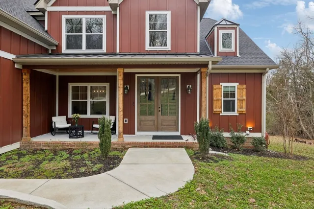 a view of staircase with wooden floor and white walls
