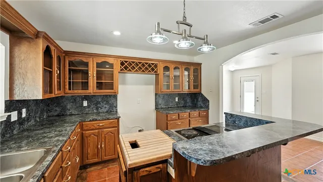 a kitchen with stainless steel appliances granite countertop a stove and a sink