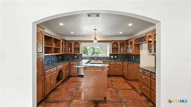 a kitchen with stainless steel appliances granite countertop a stove and a refrigerator