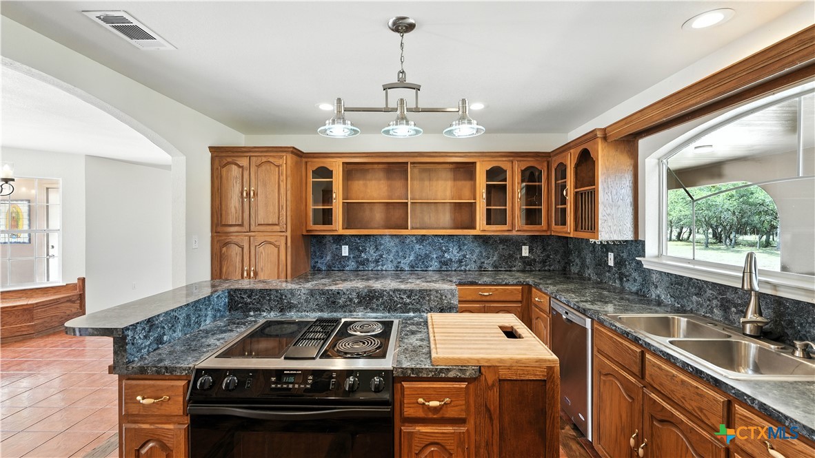 220 Lanier Ranch Road Driftwood, TX 78619 - Photo 13 of 48 a kitchen that has a sink and a stove