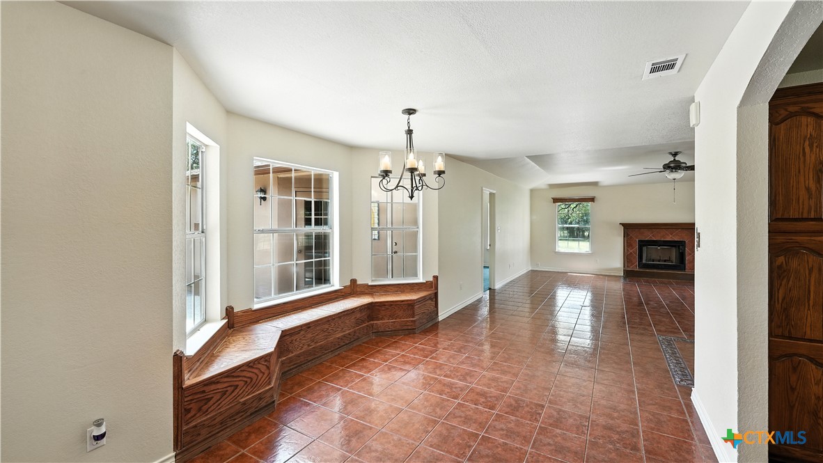 220 Lanier Ranch Road Driftwood, TX 78619 - Photo 15 of 48 a view of a hallway with wooden floor and a kitchen